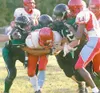 ROBERT DeBERRY/Frontiersman A group of Colony Knights bring down
the ball carrier during Colony’s 27-7 win over the East Anchorage
Thunderbirds at Colony High School last week. The Knights, w