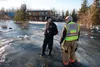 Otto Feather, deputy director for the Mat-Su Borough Fire Department and Butte Deputy Fire Chief Eric Van Dusen survey flooding near Mile 14, Old Glenn Highway Saturday afternoon. Recent warm