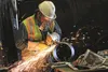 Seth Fiver of Wasilla grinds a piece of pipe for a truckable module headed to Gathering Center 2 in Prudhoe Bay. HEATHER A. RESZ/Frontiersman.com