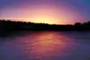 ROBERT DEBERRY/Frontiersman A colorful sunset paints the thin
ice of Wasilla Lake a deep hue of orange and blue recently. Valley
lakes and ponds have started freezing over but are not safe fo