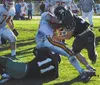 Colony's Jake DeBuck (left) and David Craig (right) swarm West
Valley's Justin Ferringer during a second-quarter run for short
yardage. TIM BRODT/Frontiersman