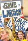 Maddie Clark,9, a Larson student, holds her sign during the Mat-Su School Board and Mat-Su Borough Assembly joint meeting March 24. J. David McChesney/Frontiersman