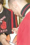 JEREMIAH BARTz/ Frontiersman Wasilla junior Dexter Pearce signs
a basketball during a special lunch of the Warrior basketball
squads on Wednesday. The basketballs, autographed by all of the
p