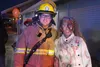 Palmer Fire and Rescue firefighter Chris Walsh poses for a photo with Mattison Sperry. Sperry, 13, attends the event every year. Jacob Mann/Frontiersman