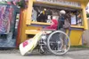 ROBERT DeBERRY/Frontiersman Katie Pauala waits in her wheelchair
for her drink outside the Kaladi Brothers Coffee stand at the
Alaska State Fair Thursday afternoon.