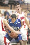 Palmer Moose Justin Draughon takes control of the rebound during
Thursday's game against the Kenai Kardinals. (ROBERT
DeBERRY/Frontiersman)