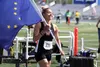 Wasilla junior Olivia Davies jogs with the Alaska flag as she celebrates her win in the Division I girls' 100 meters during the ASAA/First National Bank State Track and Field Championships Sa