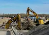 Construction crews work on a temporary streambank as part of the Parks Highway Phase 3 at Big Lake Rd
