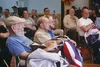Army veteran Dean Hubbard, left, sits with fellow servicemen after receiving a handmade quilt from the Quilts of Valor Foundation in recognition of his service. A Quilts of Valor sewing bee i