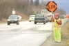 GREG JOHNSON/Frontiersman Vivian Weaver, a flagger for QAP
construction, works along the Palmer-Wasilla Highway Mnday near the
intersection of Westside Drive .