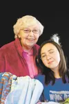Rozann and Amanda Kimpton stand with a couple of fleece blankets they made for children in the local foster care system. The grandmother-granddaughter duo received the first Mat-Su Good Neigh