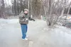 Settlers Bay resident Dameon Kowalke points to where water is still bubbling up creating ice problems on Settlers Bay Drive. ROBERT DeBERRY/Frontiersman.com