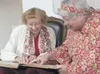 Pat Lawton, 93, and Rosemary Vavrin look at a bound volume of the Frontiersman from 1948 during an open house at the newspaper Wednesday for departing Publisher Kari Sleight. Lawton has subsc