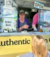 Jeanean Fontenot, co-owner of Nonkie Be’s Cajun Faves food trailer, greets a lunchtime customer during a Friday Fling in Palmer in May. The Valley-based operation will be open for business al