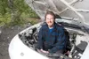 ROBERT DeBERRY/Frontiersman Inventor Chris Hunter sits inside
the empty engine compartment of a 1993 Geo Storm he is converting
to an electric vehicle of his own design. Hunter won $10,000 in