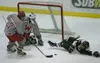 Wasilla sophomore Jeremiah Dargis knocks the puck away from his
own goal during the Warriors' 4-1 win over the Colony Knights at
the Curtis C. Menard II Memorial Ice Arena on Saturday. Dargis