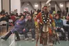 Attendees of the 2015 Alaska Native and American Indian Education Program's Winter Festival admire the regalia of a ceremonial dancer at Mat-Su Career and Technical High School Friday evening