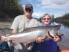 Lois Swensen, right, poses with guide Andy Couch and the king salmon she caught in a Valley fishery in May of 2015. File photo courtesy of Evan Swensen