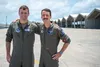 U.S. Air Force Capt. Tyler Guss, 128th Airborne Command and Control Squadron E-8C JSTARS aircraft commander, left, and Capt. George Guss, 44th Fighter Squadron F-15C pilot, pose for a photo a