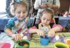 Jenna Marletto, 2, and her sister Kaylee, 5, dye their Easter eggs during an egg coloring event at the Palmer Elks Lodge Friday evening. Robert DeBerry/Frontiersman