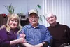 Mat-Su Regional Hospice volunteers Sandra Falkner and Paul Supina smile by their friend and patient Arthur Jennings, who began receiving home care for his chronic obstructive pulmonary diseas