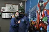 Aegis Comics of Alaska owners Luis and Amie Jo Nieves stand in front of the store's Christmas tree. Jacob Mann/Frontiersman
