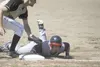Alaska Road Warriors veteran David Newman slides back into first base in a recent game against South. The Road Warriors swept Fairbanks in a doubleheader at McManus Field in Wasilla on Sunday