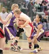 ROBERT DeBERRY/Frontiersman Houston’s Zack Qual cuts through a
pair of defenders during a game against Lathrop High School earlier
this year. Qual will play for Jamestown College next year.