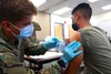 Spc. Tyler Boyer, a Hayden, Colorado native and medical specialist assigned to the 1st Stryker Brigade Combat Team, 4th Infantry Division, administers the COVID-19 vaccine at Fort Carson, Col