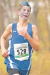 ROBERT DeBERRY/Frontiersman Painted in war paint and a blue
mohawk, Palmer's Wilie Mangelsdorf runs his way to a seventh place
finish Saturday at the ASAA/First National Bank 4A Cross Country