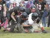 Houston’s Waylon Soptick, Tyler Forto and Allen reeder take down Kenai Kardinal Jason Daniels during Friday’s game at Houston High School. ROBERT DeBERRY/Frontiersman.com