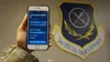 An Airman assigned to the 24th Special Operations Wing, holds a smartphone with the COVID-19 health monitoring program June 2, 2020. Medical and Preservation of the Force and Family team memb