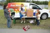 Members of the Rasmusen family pickup sack lunches from Food 4 Kids Wednesday at Newcomb Park in Wasilla. 15-year-old Piper Rasmusen volunteered for the program last year and this year has be