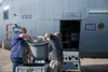 Engineers lift a satellite antenna from its storage bin to install it onto a WC-130J Super Hercules aircraft at Keesler Air Force Base, Miss., Oct. 12, 2021. The antenna is part of a satellit
