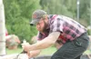 Adam Lasalle saws his way through a log during the lumberjack
show Monday afternoon at the Alaska State Fair in Palmer. ROBERT
DeBERRY/ Frontiersman