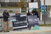 Steve Carrington and Pam Melin wave signs on Election Day. Tim Rockey / Frontiersman
