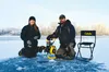 Jehnifer and Butch Ehmann kneel by their freshly drilled fishing hole in the ice on a local lake a few weeks ago. The Ehmanns said in an interview Friday morning that while the ice is still t