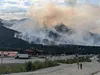 The Riley Fire burns on June 30, sending smoke over the the commercial strip outside the park in the Nenana Canyon that is known as Glitter Gulch. The area is a major hub for Denali National 