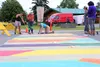 The Palmer Crosswalk Coalition paints a new crosswalk in downtown Palmer Sunday. Tim Rockey/Frontiersman