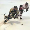 Houston's Jimmy Estes and Monroe's Michael Andre (above) each go
for the puck during the first period of Monroe's 2-1 victory over
the Hawks in the small school state championship game at the