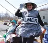 Valley Arts Alliance President Carmen Summerfield sports a 'tarp-n-tape' wearable art piece, designed by alliance member Niki Pease, while riding in a horse-drawn carriage during the fifth an