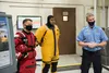 From right, 673d Civil Engineer Squadron firefighters Timothy Gonyea, U.S. Air Force Senior Airmen Uhila Afungia and Jacob Timmer, explain swift water and ice water rescue services to U.S. Ai