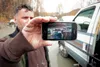 Butte resident Amir Lena holds up his Iphone with a picture of his flooded property Thursday afternoon. Lena wants to know what the borough, the state and the residents can to do to prevent s