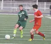 Colony senior captain Ben Atkinson chips the ball past an East Anchorage defender during a 3-0 win over the Thunderbirds on Friday. Jeremiah Bartz