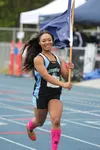 Chugiak's Ariana Davis jogs with the Alaska flag after her win in the 4A girls' 100 meters during the ASAA/First National Bank State Track and Field Championships Saturday at Palmer High Scho