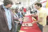 ROBERT DeBERRY/Frontiersman Wasilla residents Jim and Suzie
Seltenreich, left, learn about Chris Perry's E-Z Hook barbecue
utensil Saturday at the Mat-Su Outdoorsman Show in Wasilla. The
show