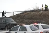 Alaska State Troopers gather evidence at a pullout near Mile 52, Glenn Highway Thursday related to the shooting death of Frank L. Pushruk, 45, of Palmer. ANDREW WELLNER/Frontiersman.com