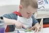 Liam Bottoms, 4, puts paint and brush to canvas Thursday
afternoon at Doodles Art Studio. (ROBERT DeBERRY/Frontiersman)