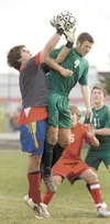 Wasilla keeper Eli Tingstad, left, snags the ball as Colony’s
Jesse Rouse goes for a header during a previous game at Wasilla
High School. Tingstad has signed a National Letter of Intent to
p