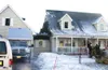 ANDREW WELLNER/Frontiersman Clean-up progresses Monday hours
after an early morning fire severely damaged this house near
Palmer